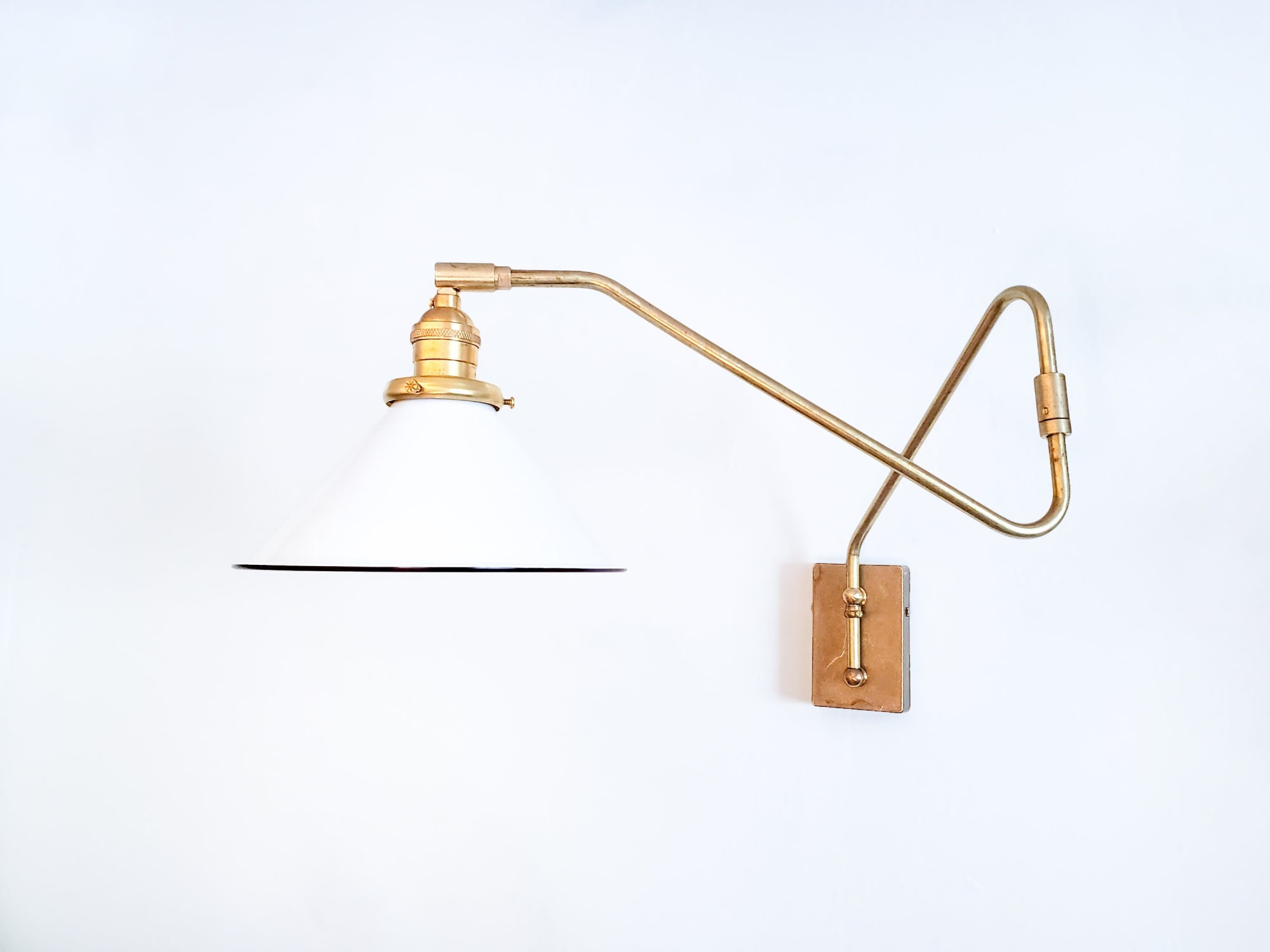 Modern swing store arm sconce