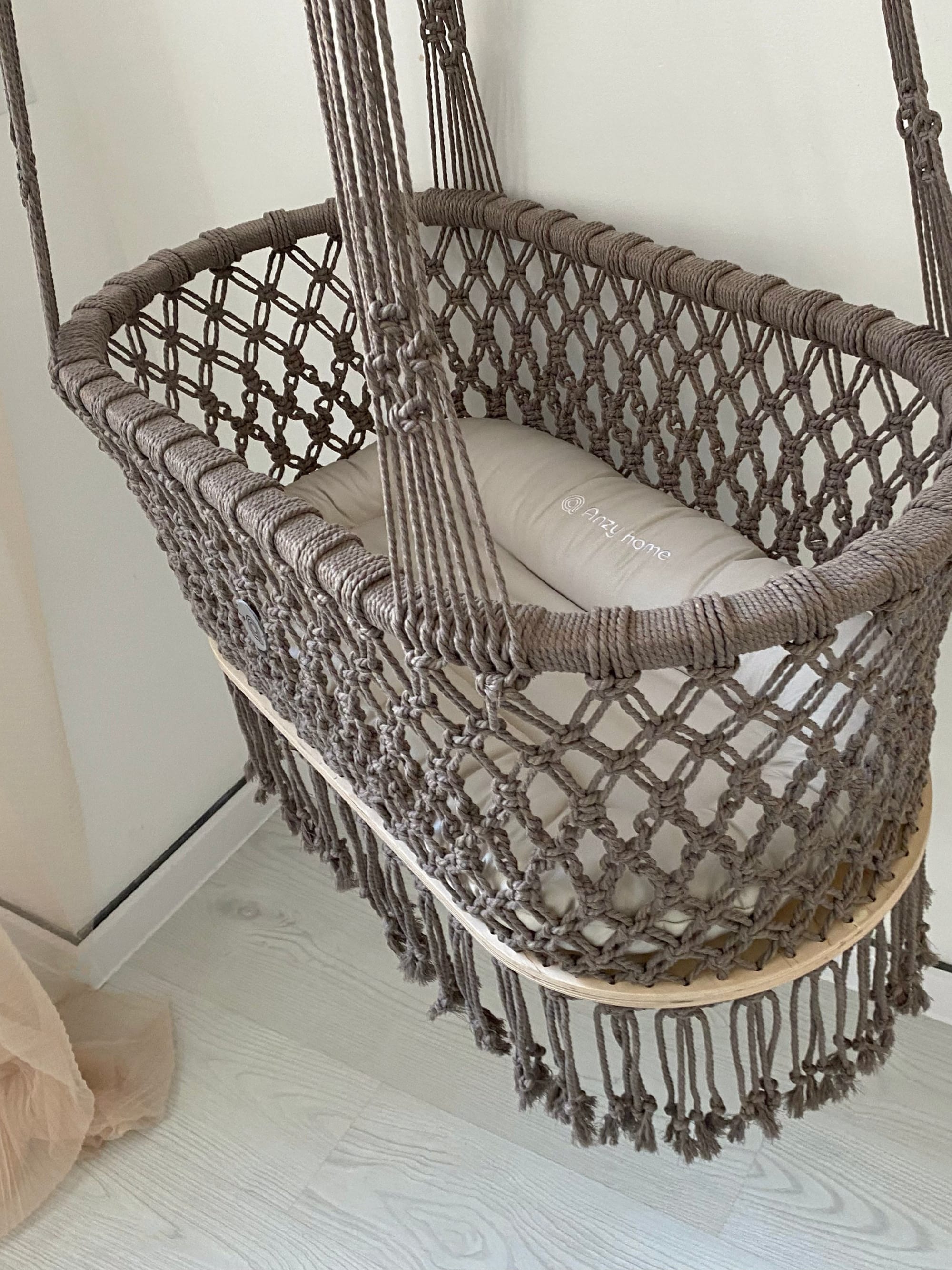 Hanging macrame baby bassinet by Anzy Home