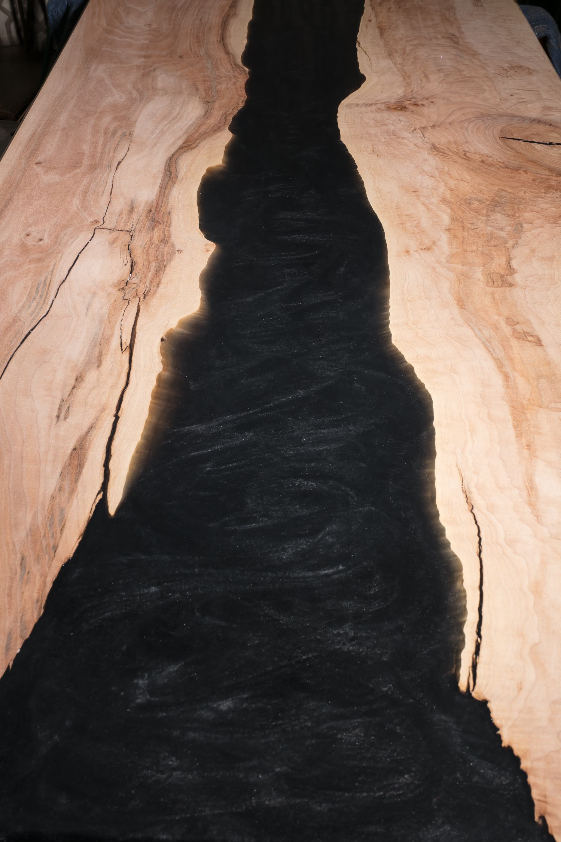Light natural wooden and black river table detail