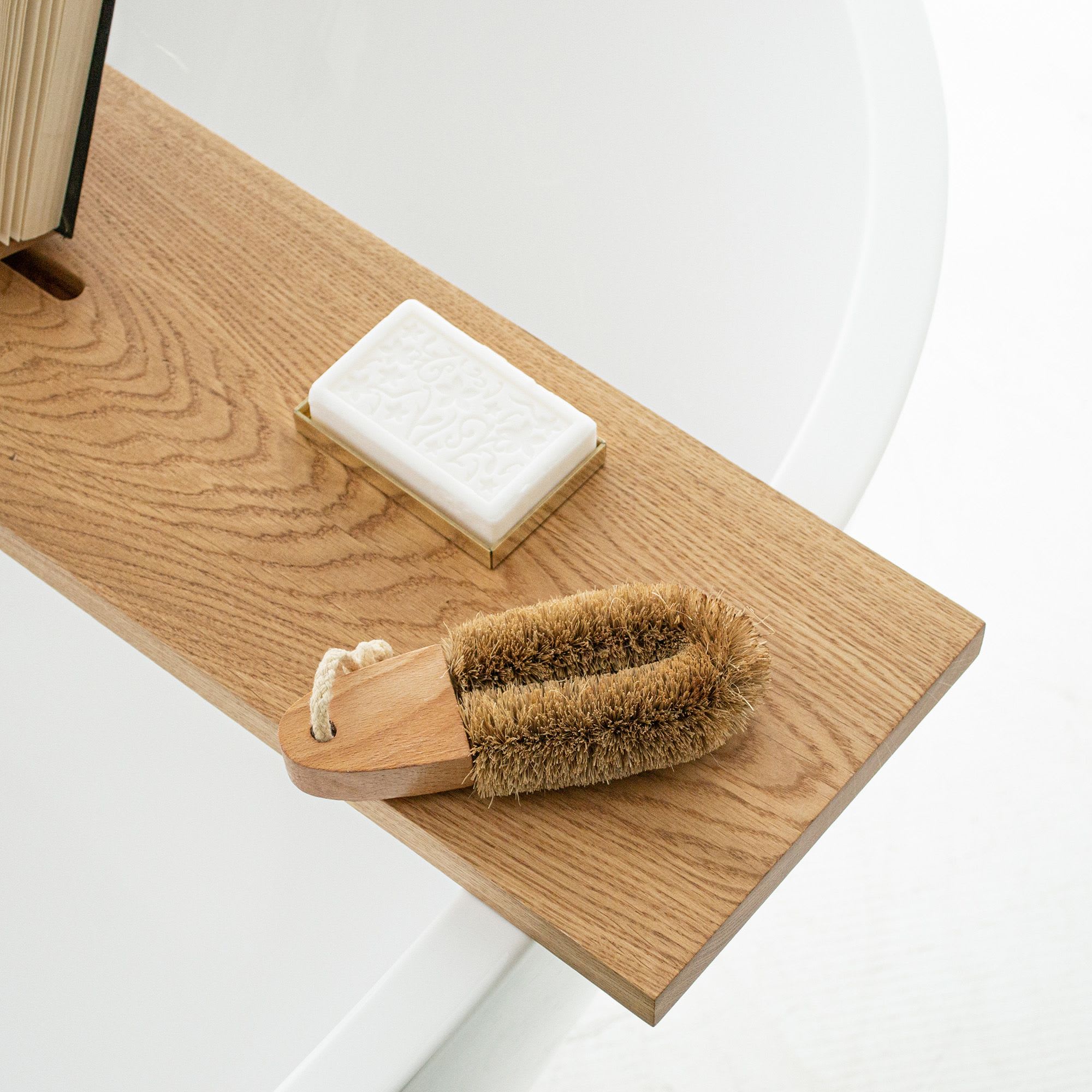 Different toilet cleaning supplies on wooden table in bathroom