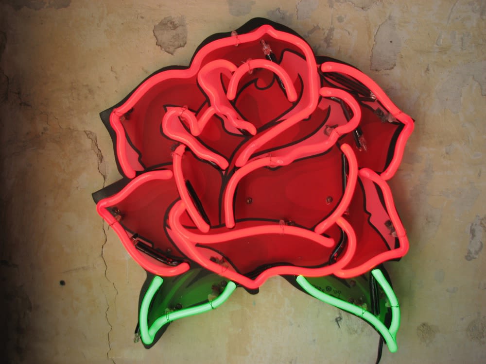 Large red neon rose art by Austin creators