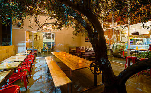 Communal Oak Tables | Tables by Arika Jacobs Design Studio | Sage Vegan Bistro - Culver City in Culver City