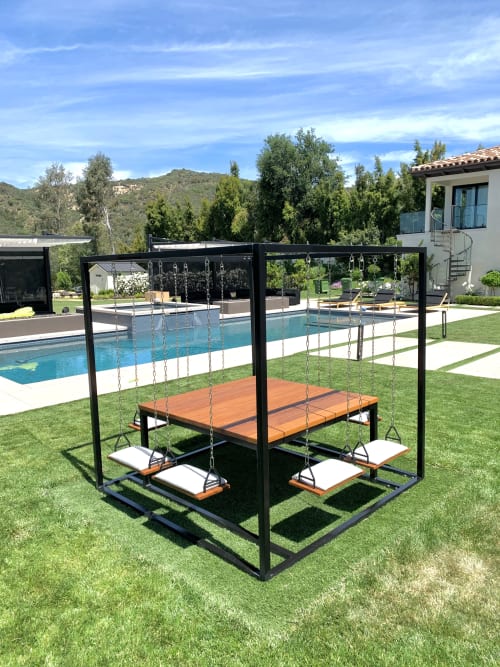 Kevin Hart's Black 8-Seater SwingTable Teak | Tables by SwingTables | Kevin Hart's Home in Calabasas