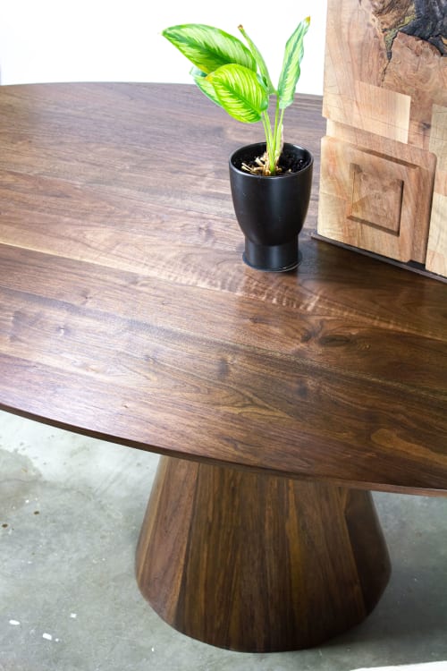 Walnut Oval dining table with conical base | Tables by LIRIO Design House