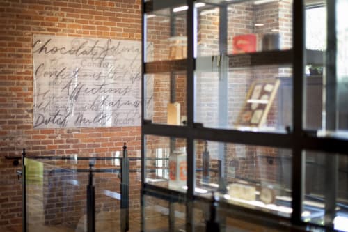 Script plexiglass painting | Paneling in Wall Treatments by Clementine Studio | The Charmant Hotel in La Crosse