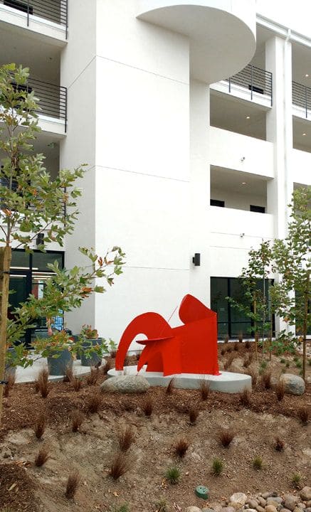 "What is big and red and eats rocks?" | Sculptures by Nina Karavasiles | TALMADGE GATEWAY Apartments in San Diego