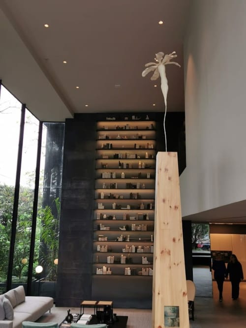 Bookcase with books and bottles in natural clay | Public Sculptures by Estudio Manus | São Paulo in São Paulo