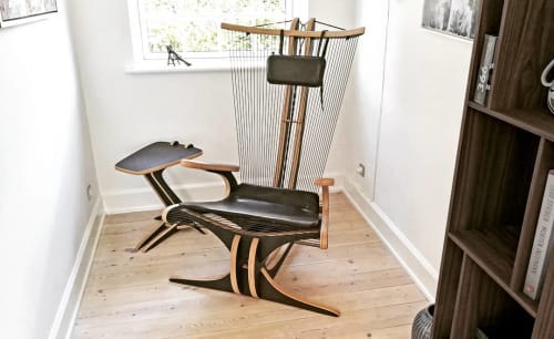 Hippokamp Lounge Chair & Footstool - with black leather cushions | Chairs by Peter Qvist