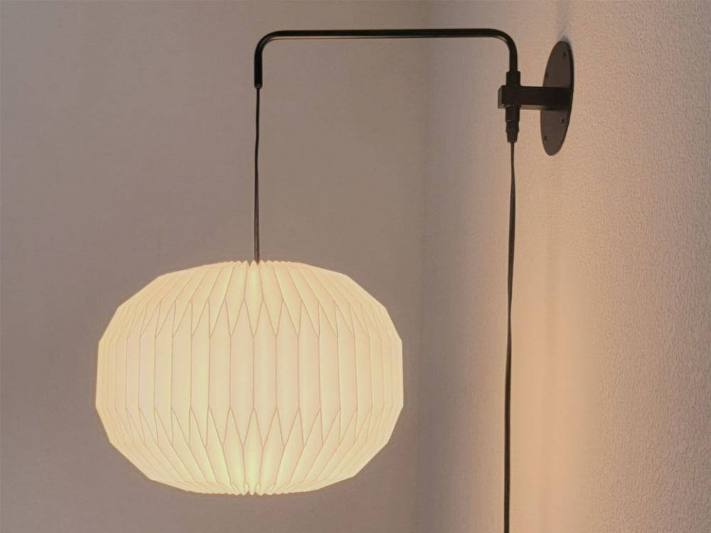 Industrial sconce with pleated round lampshade by Studio Pleat