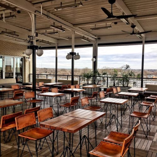 Low-Back Saddle Leather Chairs and Slatted Cafe Tables | Chairs by Garza Marfa | The Durham Hotel in Durham