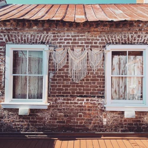 Macrame Wedding Decor | Macrame Wall Hanging in Wall Hangings by Rosie the Wanderer | Upstairs At Midtown | Charleston SC Wedding and Event Venue in Charleston. Item composed of fiber