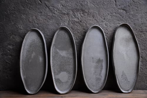 Organic natural shape elongated stoneware plates in grey | Dinnerware by Laima Ceramics. Item made of stoneware works with minimalism & contemporary style
