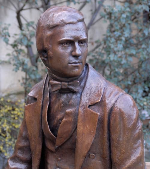 Young Darwin Statue | Public Sculptures by Anthony Smith Sculpture | Christ's College Cambridge in Cambridge. Item composed of bronze and stone