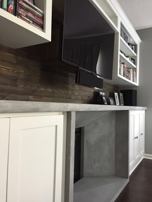Cement and wood fireplace wall | Fireplaces by Kula Solutions. Item composed of wood and cement