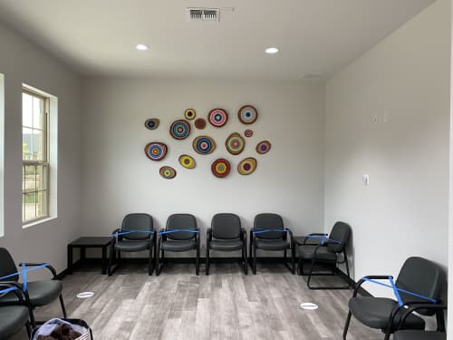 A Wall of Wooden Circle Slices | Wall Sculpture in Wall Hangings by Modern Slice. Item made of wood with synthetic