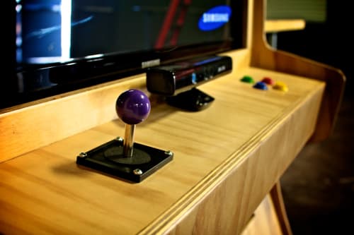 Custom Wood Arcade | Media Console in Storage by Monkwood Studios | The Vault in Orange. Item made of wood