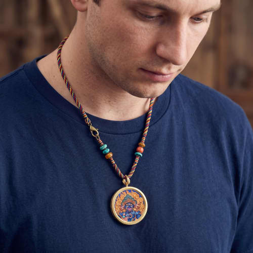 Handcrafted Blue Wealth Deity Thangka Amulet Pendant Art | Ornament in Decorative Objects by Dynasty Artisan. Item composed of metal in eclectic & maximalism or asian style