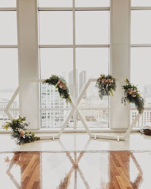 6' Woven Fiber Hexagons w/ Fresh Florals | Decorative Frame in Decorative Objects by Tiffany Lusteg | Ultimate Sky Box at Diamond View Tower in San Diego. Item made of wood & fiber