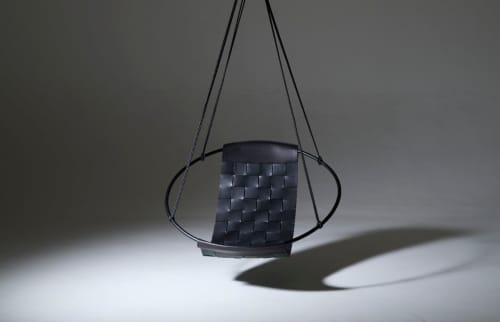 Genuine Leather Woven into a Hanging Swing Chair | Accent Chair in Chairs by Studio Stirling. Item made of steel & leather compatible with boho and minimalism style