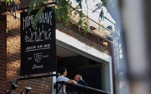 Exterior flag signage for Home of the Brave bar | Signage by CONTINO | Home of the Brave in Toronto