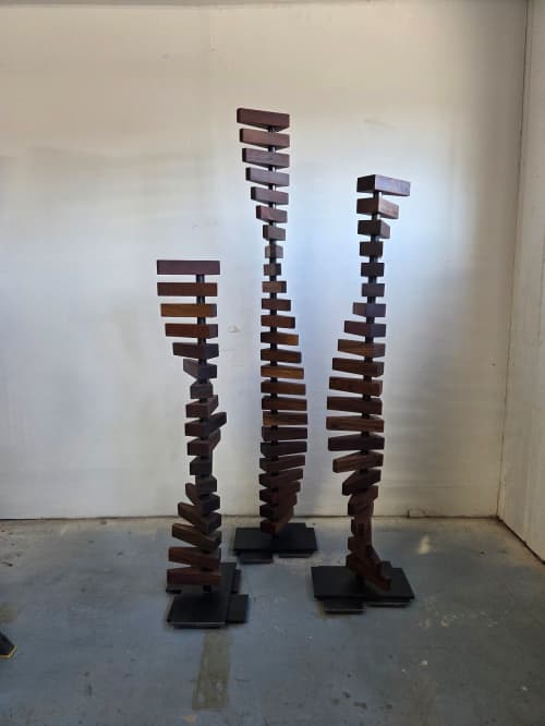 Stacks Series: Walnut Helices | Sculptures by Where Wood Meets Steel. Item made of walnut with steel works with modern style