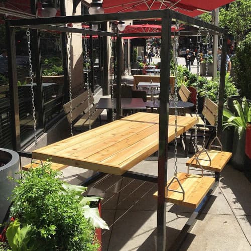 Raw Steel 4-Seater SwingTable Cedar | Picnic Table in Tables by SwingTables | Virgin Hotels Chicago in Chicago. Item made of wood with steel