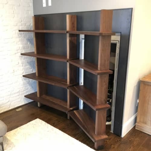 Custom Walnut Shelving Unit with Hidden Closet Door | Storage by Joe Cauvel of Cauv Design. Item made of walnut with steel