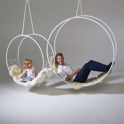 Studio Stirling Ndebele Wheel | Swing Chair in Chairs by Studio Stirling. Item composed of brass compatible with minimalism and modern style