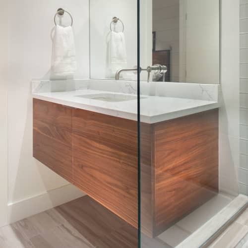 Custom floating vanity | Toiletry in Storage by Kenichi Woodworking. Item made of walnut