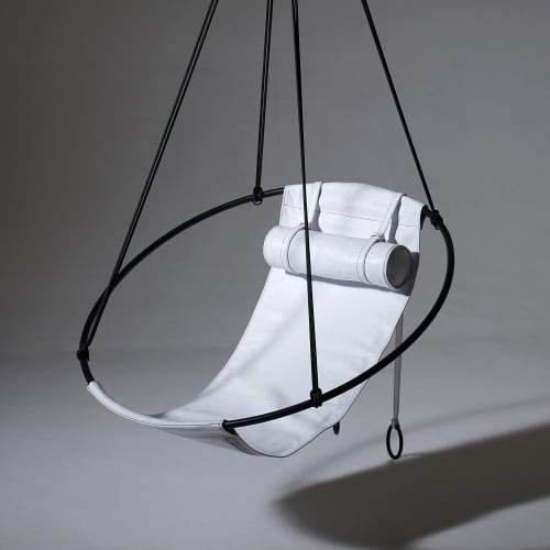 Soft Leather Swing in Santorini, Greece | Easy Chair in Chairs by Studio Stirling | Abyss Santorini in Oia. Item made of steel with leather works with boho & art deco style