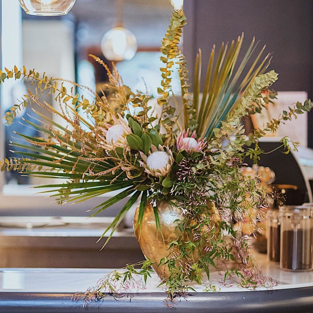 Art deco revival gold urn with bouquet