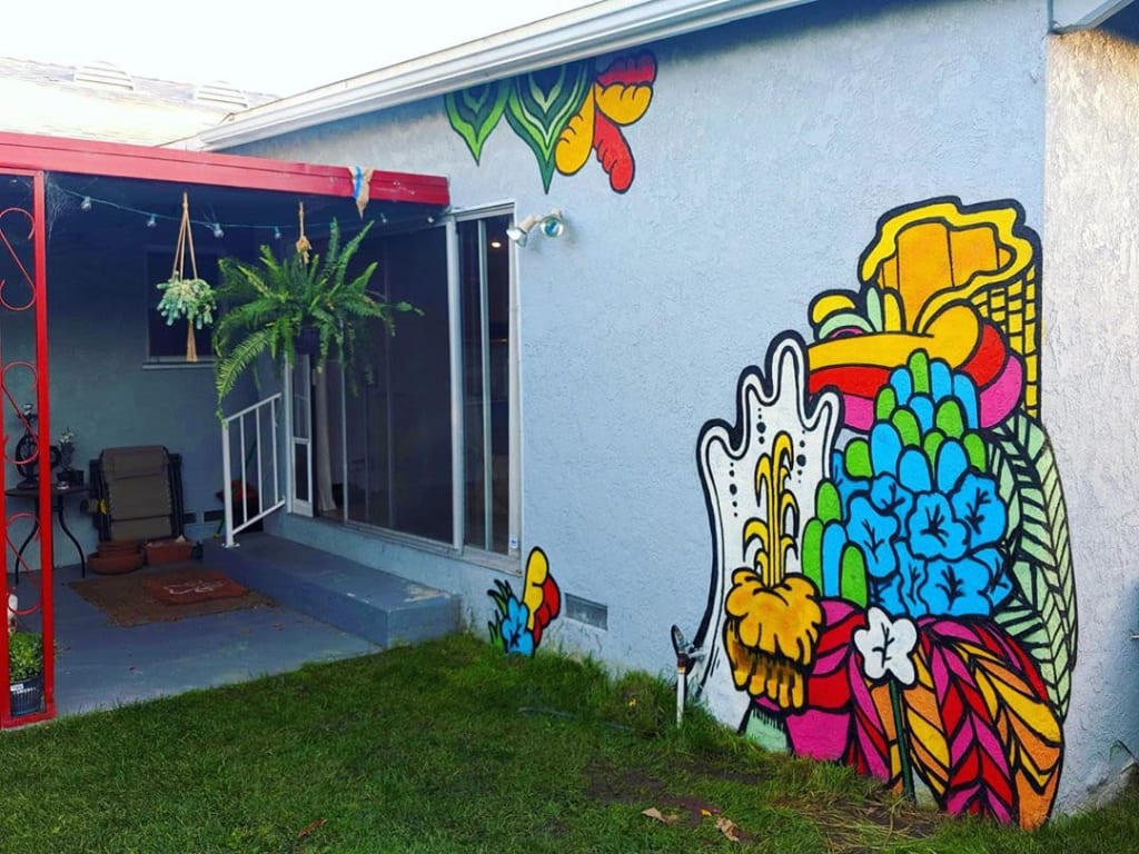 Mural by Darin on the side of a private residence in Culver City, CA. Bright Colors, 70's Vibe Plants.