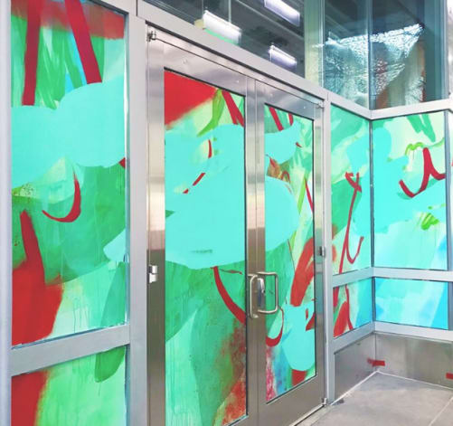 Red and blue abstract window mural by Nicole Mueller in the Salesforce Transit Center