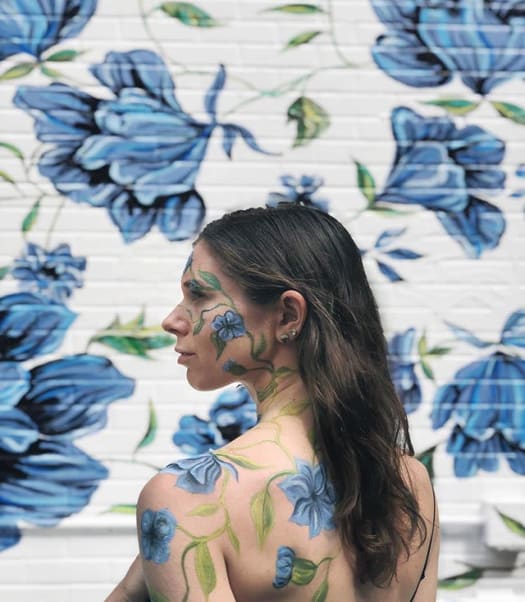 Natasha aka Surface of Beauty in front of her mural located at Yumi Kim, New York, NY