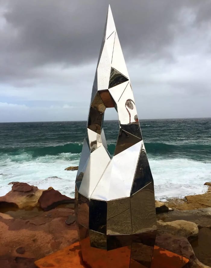 Reflective modern public sculpture near the sea