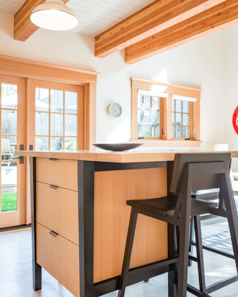Light natural wood kitchen island cabinets with dark wood