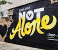 You Are Not Alone | Street Murals by Jason Naylor | Leslie's Kitchen in Brooklyn. Item made of synthetic