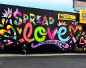 Spread Love | Street Murals by Jason Naylor | EZ Pawn Corp in Brooklyn. Item made of synthetic