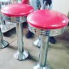 Red Floor Mounted Stools - Model 6050-303 | Chairs by Richardson Seating Corporation | Baltimore/Washington International Thurgood Marshall Airport in Baltimore. Item made of fabric & brass