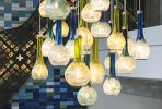 Cascade | Chandeliers by Illuminata Art Glass Design by Julie Conway | Ovation 309 in Madison. Item made of bronze with glass works with contemporary & eclectic & maximalism style