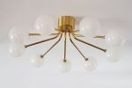 Orbit | Chandeliers by ILANEL Design Studio P/L | CAULFIELD VILLAGE in Caulfield North. Item composed of brass and glass
