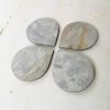 Light gray stone coasters "Drops". Set of 4 | Tableware by DecoMundo Home. Item composed of fabric & stone compatible with minimalism and modern style