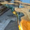 Live edge Clear Epoxy Table made from olive wood | Dining Table in Tables by Ironscustomwood. Item composed of wood and synthetic