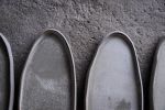 Organic natural shape elongated stoneware plates in grey | Dinnerware by Laima Ceramics. Item made of stoneware works with minimalism & contemporary style