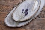 Organic natural shape elongated stoneware plates in grey | Dinnerware by Laima Ceramics. Item made of stoneware compatible with minimalism and contemporary style