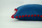 blue pillow with red pom poms // velvet pom pom pillow | Pillows by velvet + linen