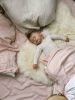 Bright Ivory Nursery Sheepskin | Small Rug in Rugs by East Perry. Item composed of fabric