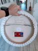White wall sculpture on a 14" round canvas, wreath art | Wall Hangings by Natasha Kanevski. Item composed of wood & fabric compatible with minimalism and contemporary style