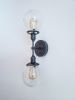2-Arm Matte Black Modern Wall Sconce Clear Shade Industrial | Sconces by Retro Steam Works. Item composed of metal in industrial style