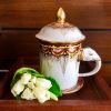 Elephant Mug with Lid & Saucer: Hand-Painted, Gold Accents | Drinkware by Artisan Homeware. Item made of ceramic